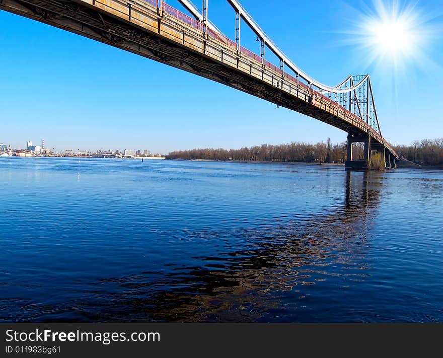 Bridge over blue river on sunny day