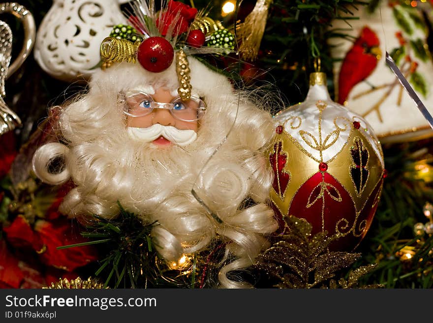 A nicely decorated christmas tree with a Santa Claus ornament. A nicely decorated christmas tree with a Santa Claus ornament