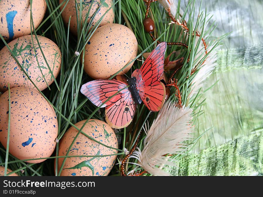 Decorated eggs in a wreath on a green background. Decorated eggs in a wreath on a green background