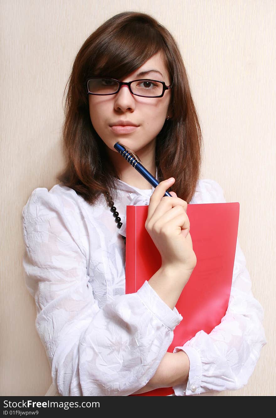 Portrait of the business woman in a white blouse and a folder of documents. Portrait of the business woman in a white blouse and a folder of documents.