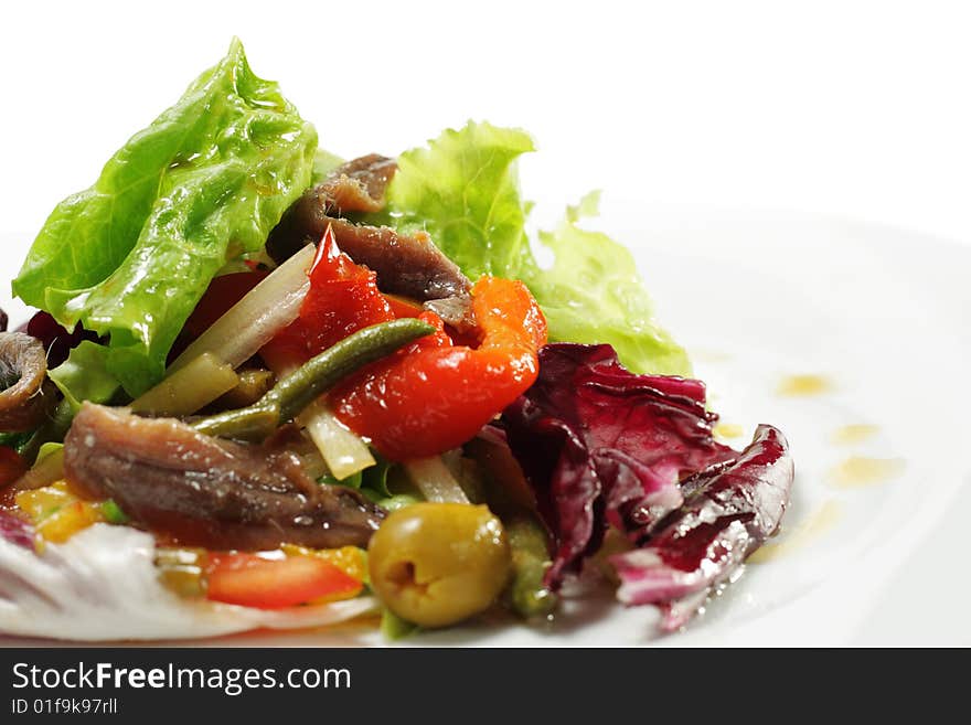 Salad with Anchovy, Olive and Vegetable Leaf. Isolated on White Background