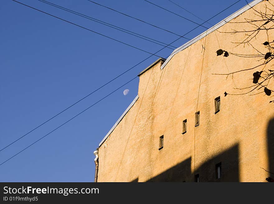 Wall, blue sky and the moon.