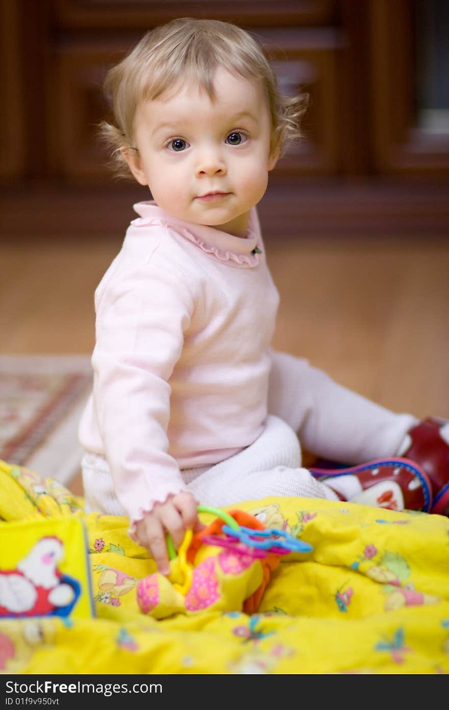 Little girl playing on the floor - shallow DOF