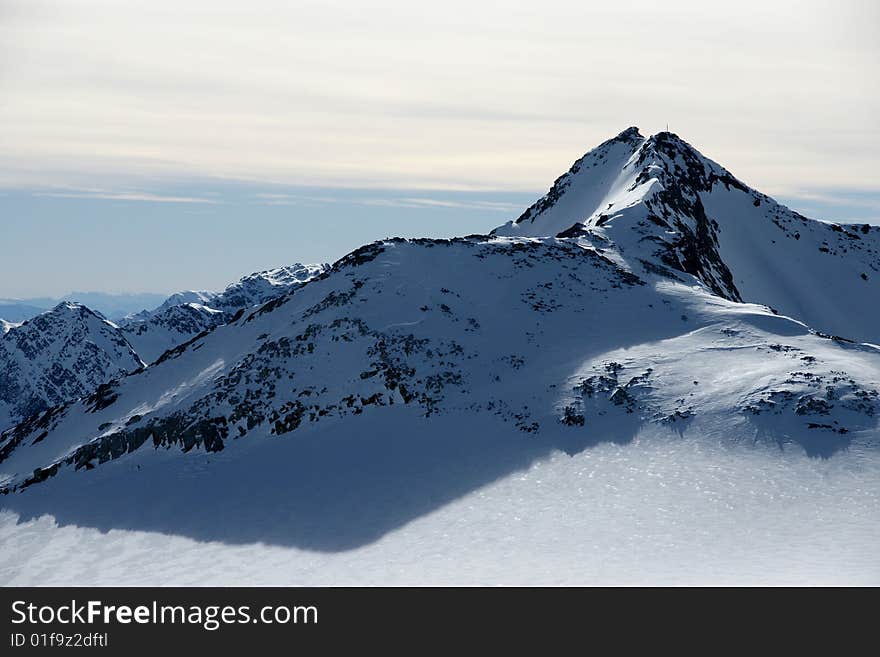 A view of winter Alps peaks in the sun in Stubai area. A view of winter Alps peaks in the sun in Stubai area.