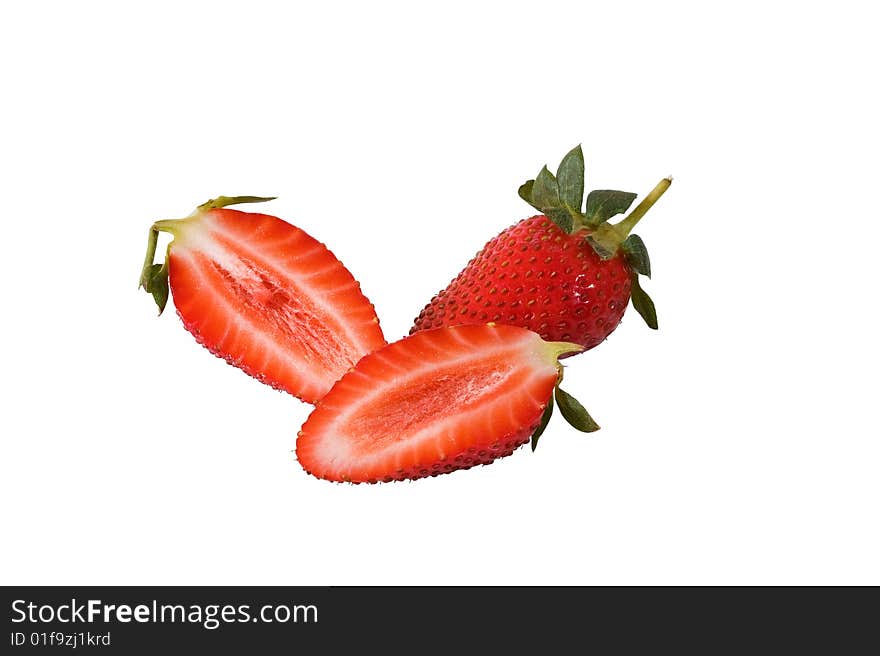 One whole strawberry with two halfs against a white background. One whole strawberry with two halfs against a white background