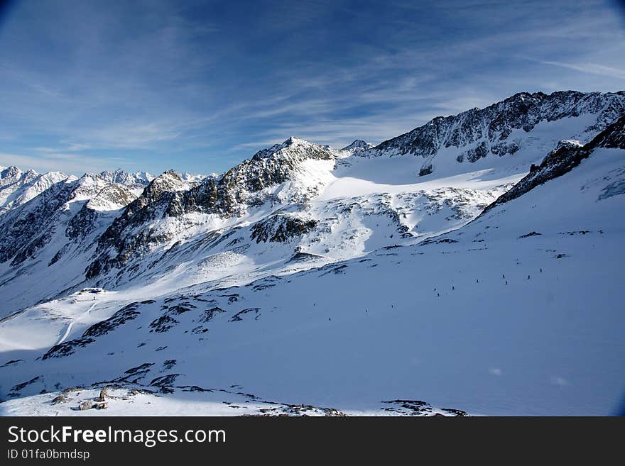 A view of winter Alps peaks in the sun in Stubai area. A view of winter Alps peaks in the sun in Stubai area.