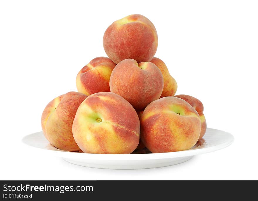 Lots of peaches on a plate isolated on white