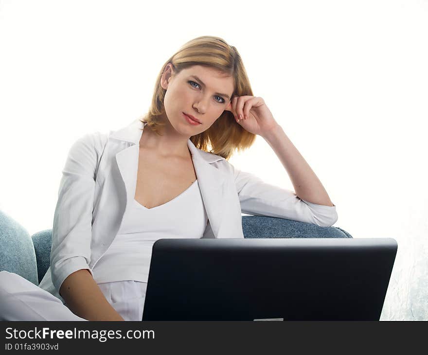 The beautiful businesswoman in a white jacket and laptop. The beautiful businesswoman in a white jacket and laptop