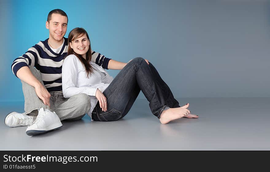 Attractive young couple sitting, enjoying a romantic moment. Attractive young couple sitting, enjoying a romantic moment