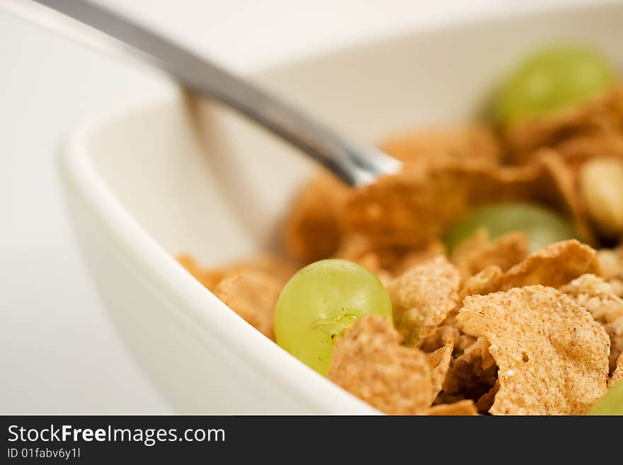 Bowl of granola cereal with fresh grape spoon. Bowl of granola cereal with fresh grape spoon