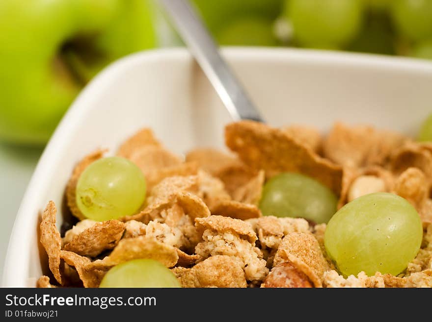 Bowl of granola cereal with fresh grape spoon. Bowl of granola cereal with fresh grape spoon