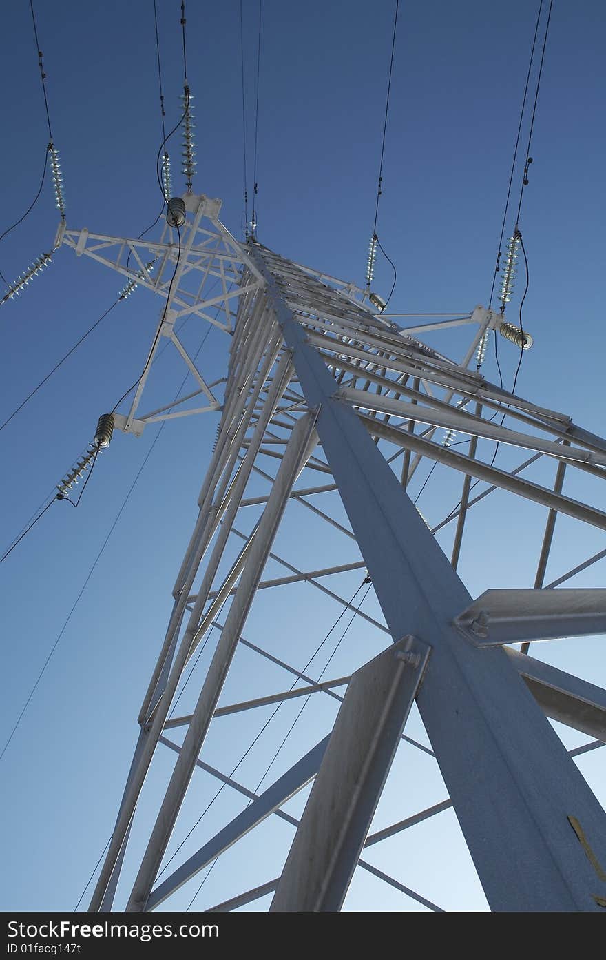 High-voltage prop against the background of blue sky. High-voltage prop against the background of blue sky.