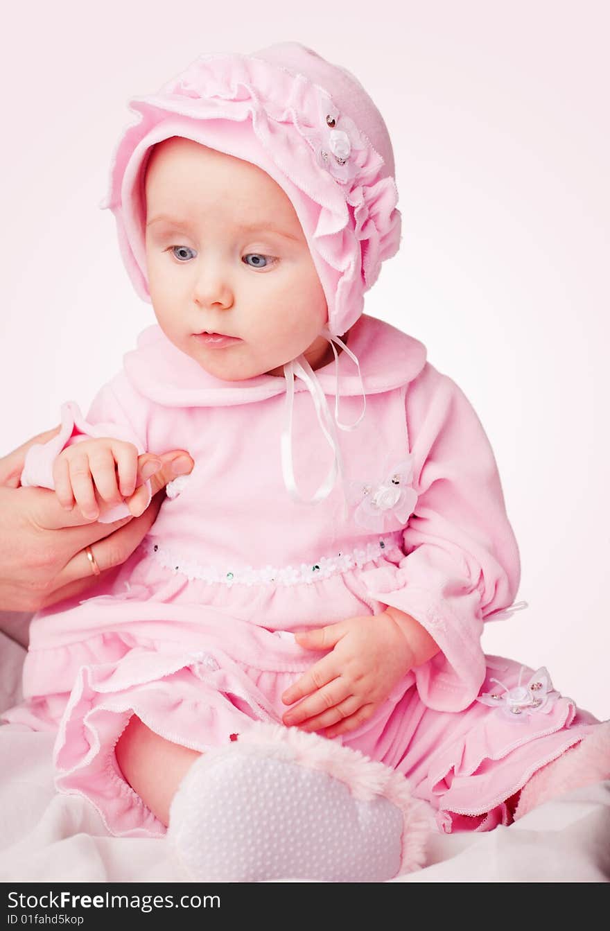 Small pretty girl in pink pajamas on white background. Small pretty girl in pink pajamas on white background