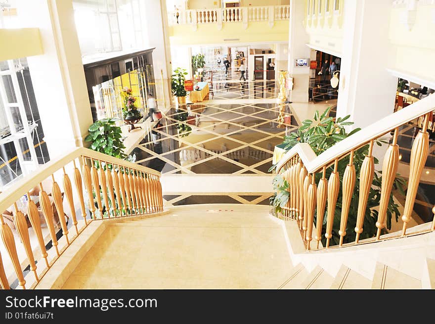 The spacious luxury hotel lobby with curving staircase. The spacious luxury hotel lobby with curving staircase.