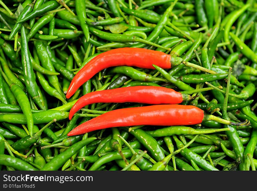 Green and red chillies in the market