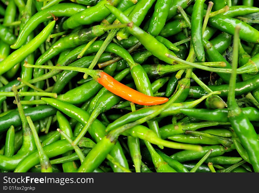 Green and red chillies in the market