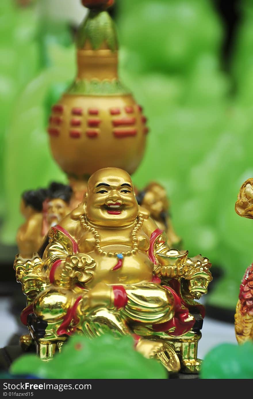 Golden Buddha for sale on sidewalk during Chinese New Year