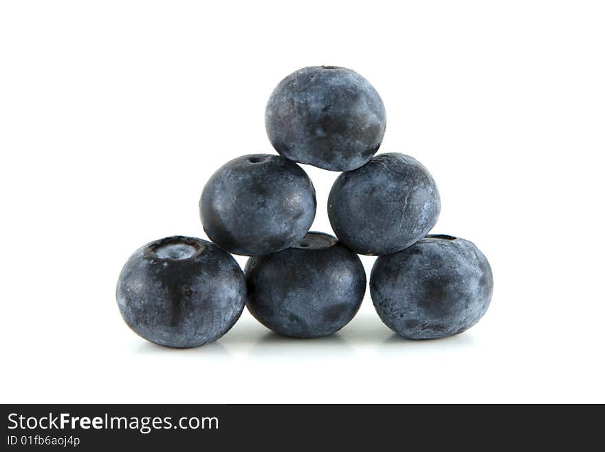 Pyramid stack of blueberries on white background.