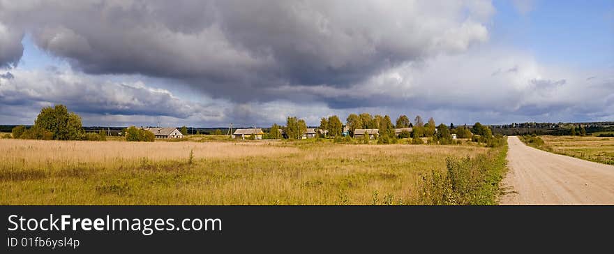 Rainbow on background of the rural landscape