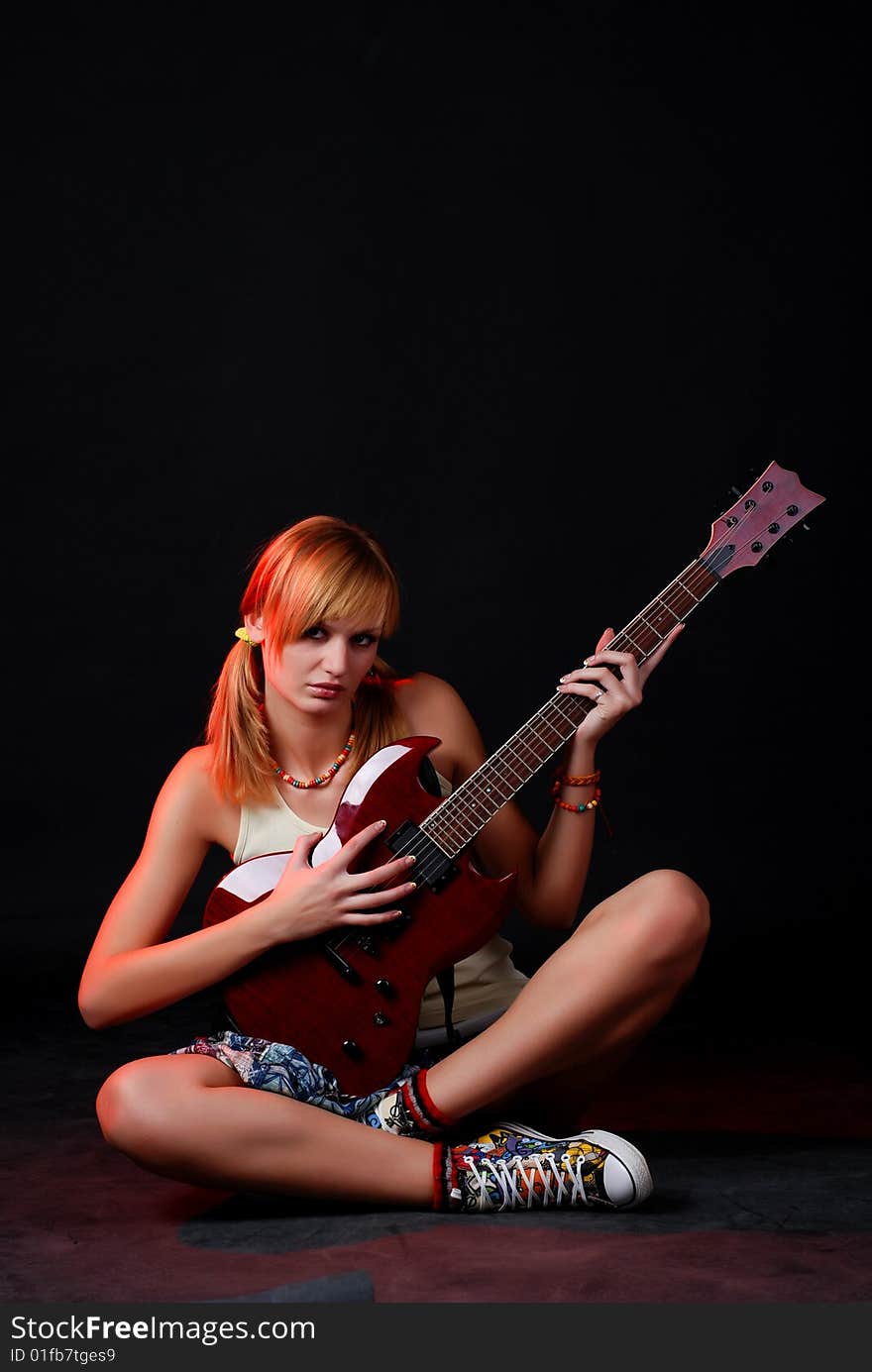 Portrait of a young woman with red electric guitar. Portrait of a young woman with red electric guitar