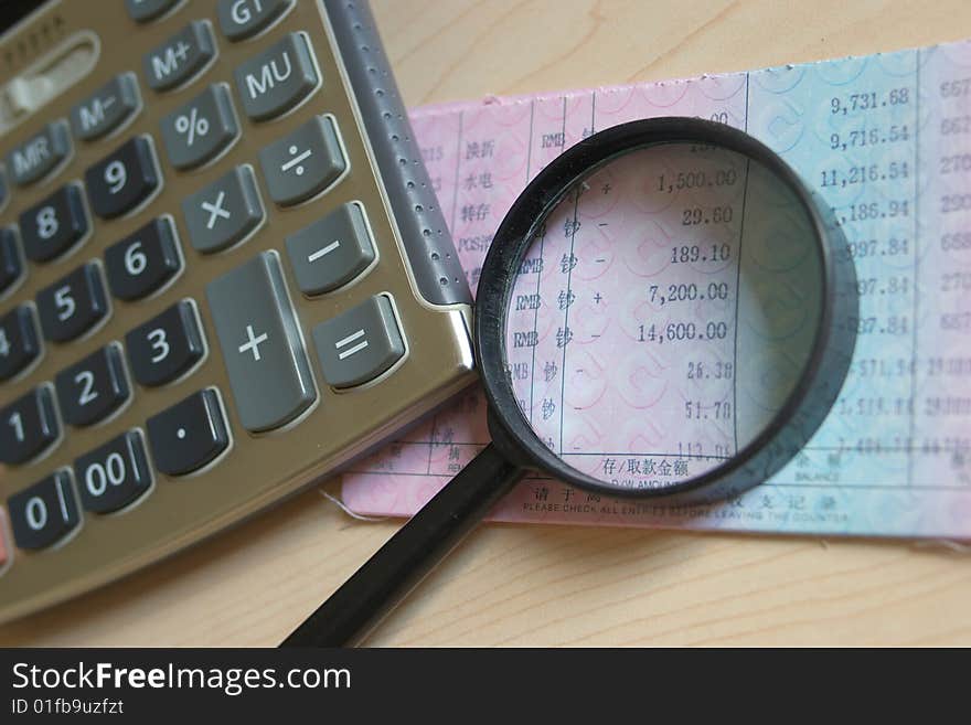 Calculator And Magnifier On Bankbook