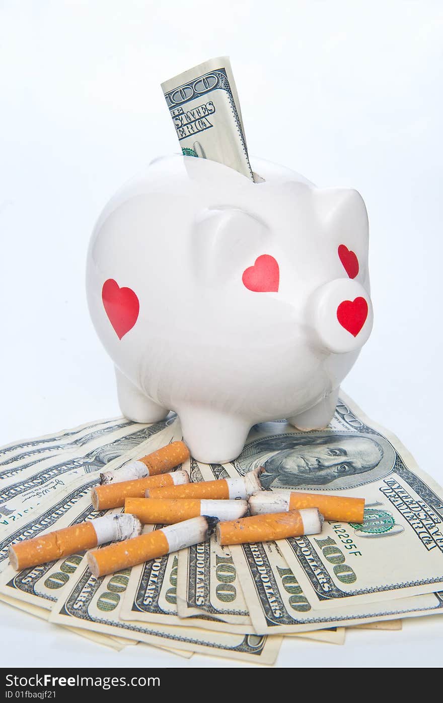 Piggybank and cigarette butts standing on money