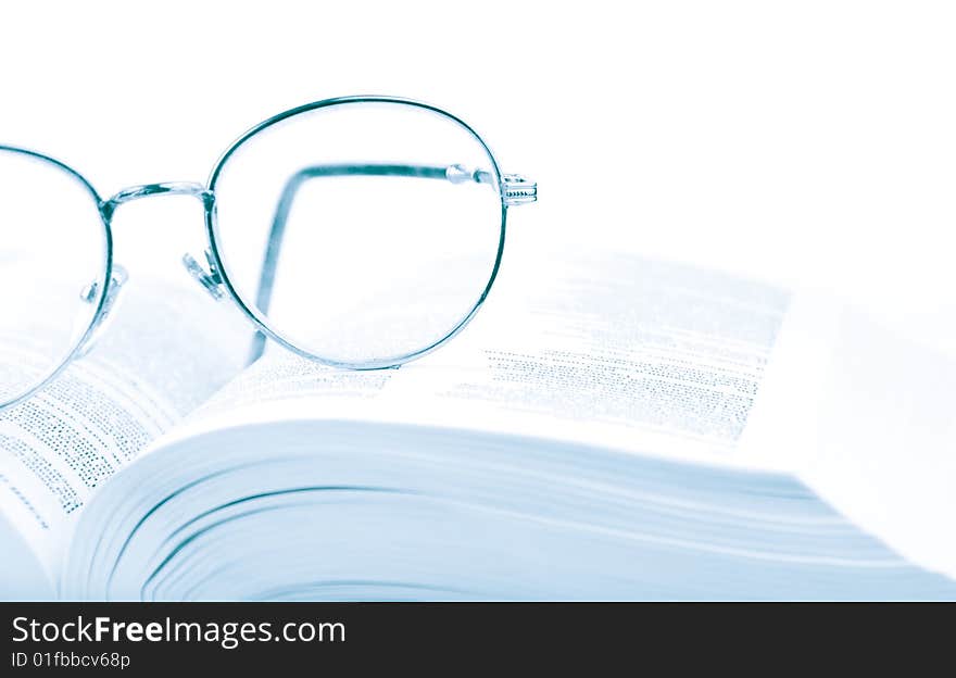 Glasses on the open book