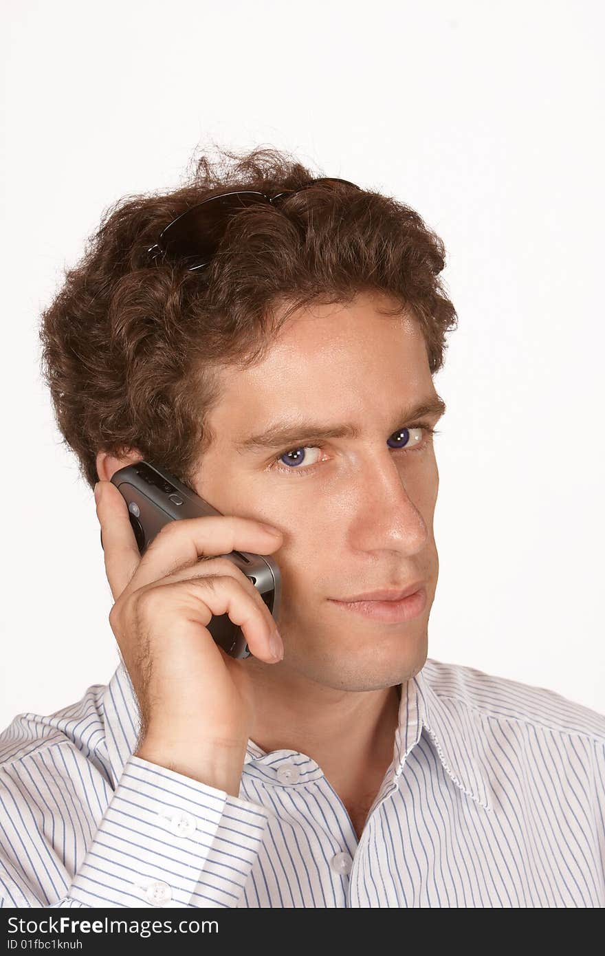 Business man talking on mobile phone with blue eyes and short brown hair. Business man talking on mobile phone with blue eyes and short brown hair