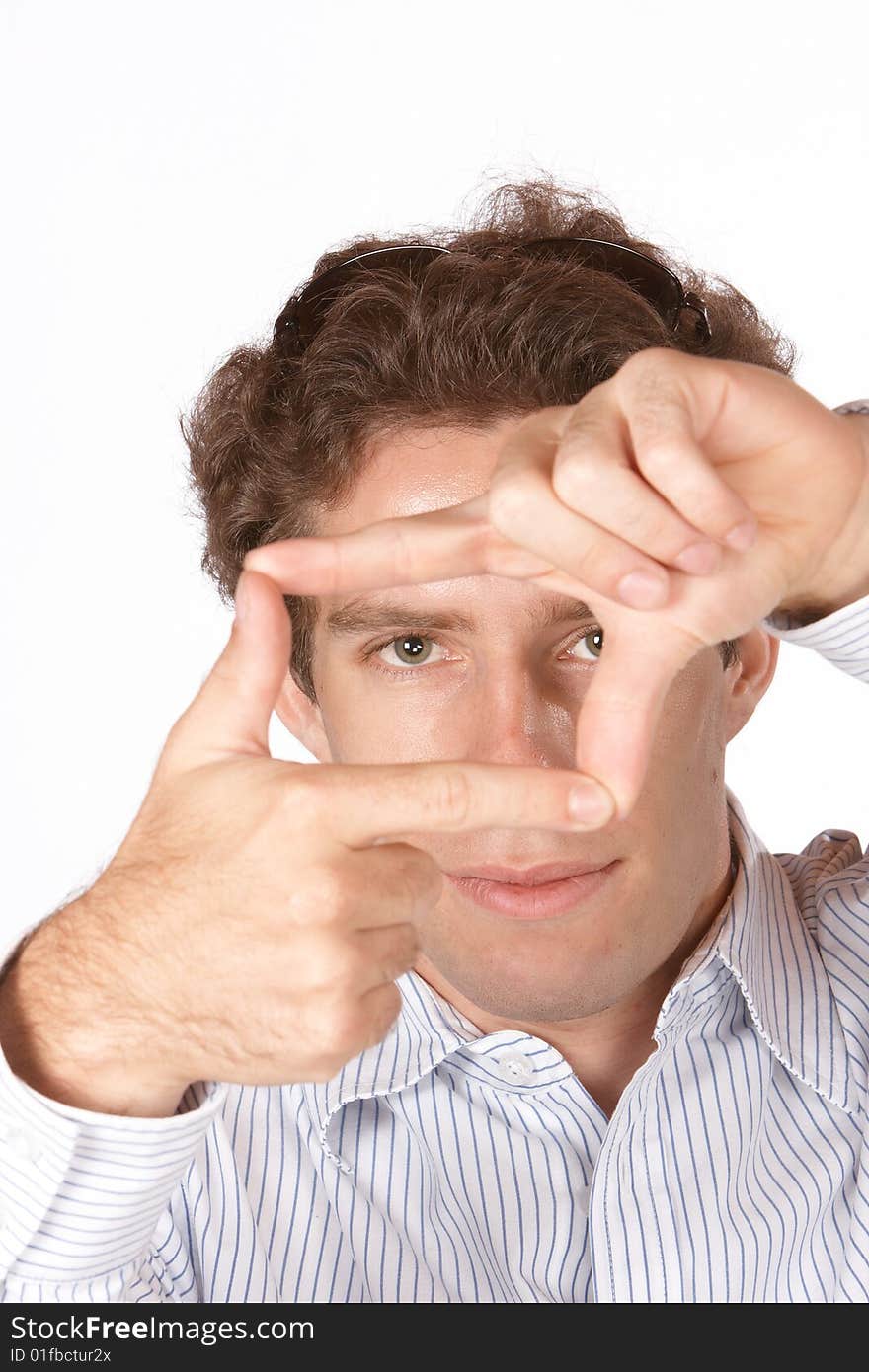 Male model looking through hands forming a square