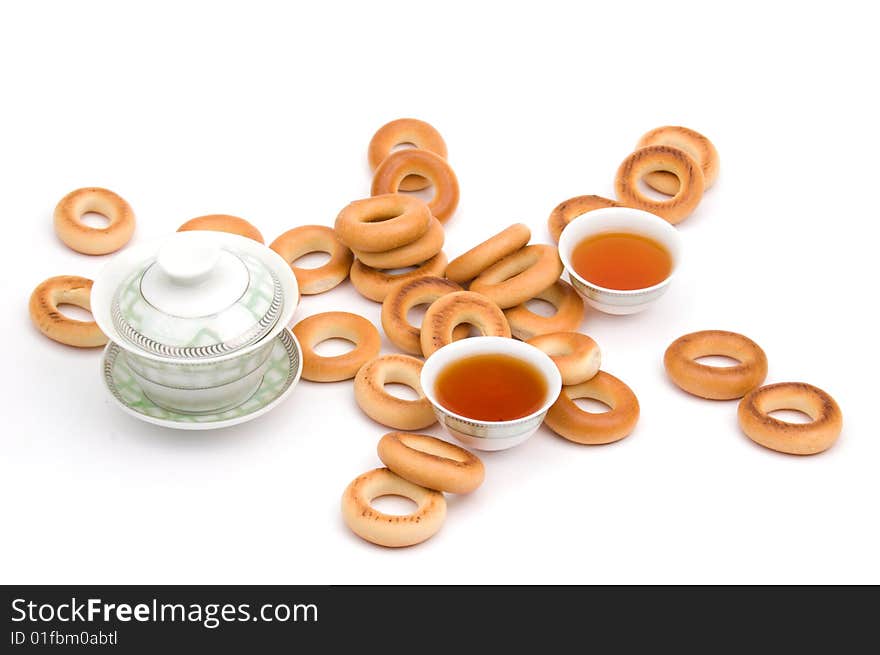 Traditional chinese tea service and bread-rings around. Traditional chinese tea service and bread-rings around