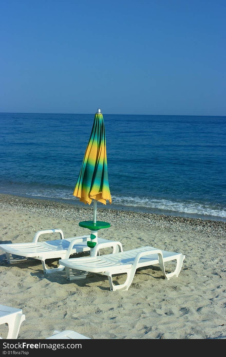 Folded umbrella on a beach