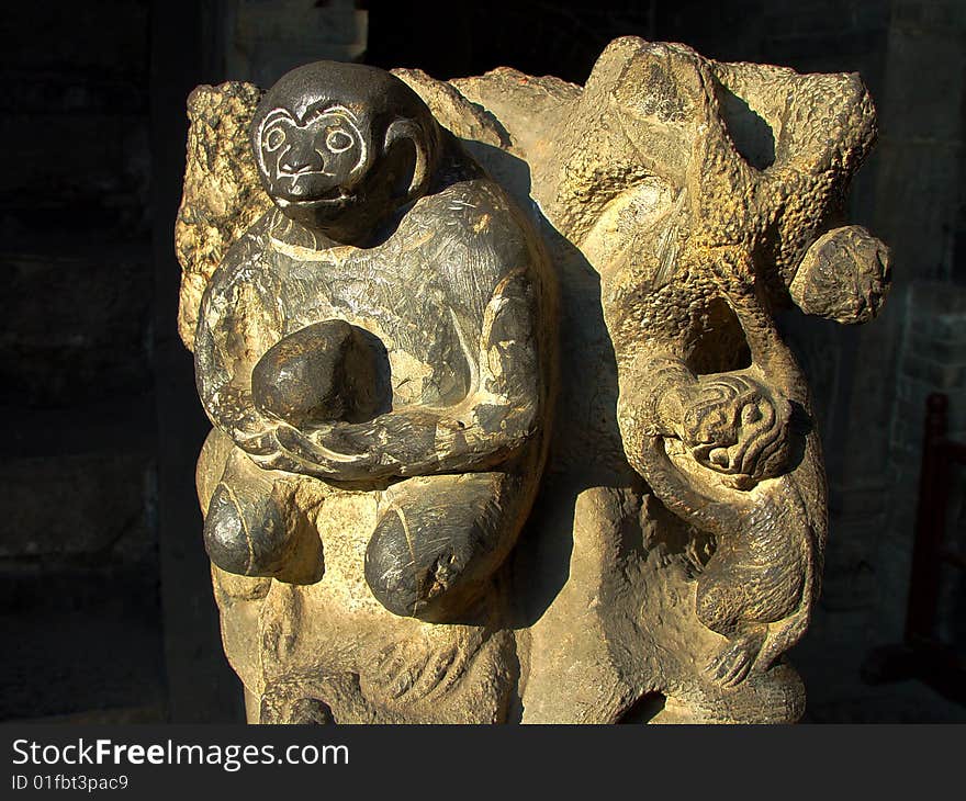 Stone carvings of a monkey with peach in hands,China's traditional crafts. Stone carvings of a monkey with peach in hands,China's traditional crafts