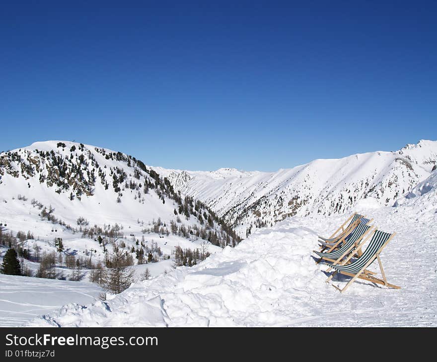 White mountains with green deckchairs. White mountains with green deckchairs