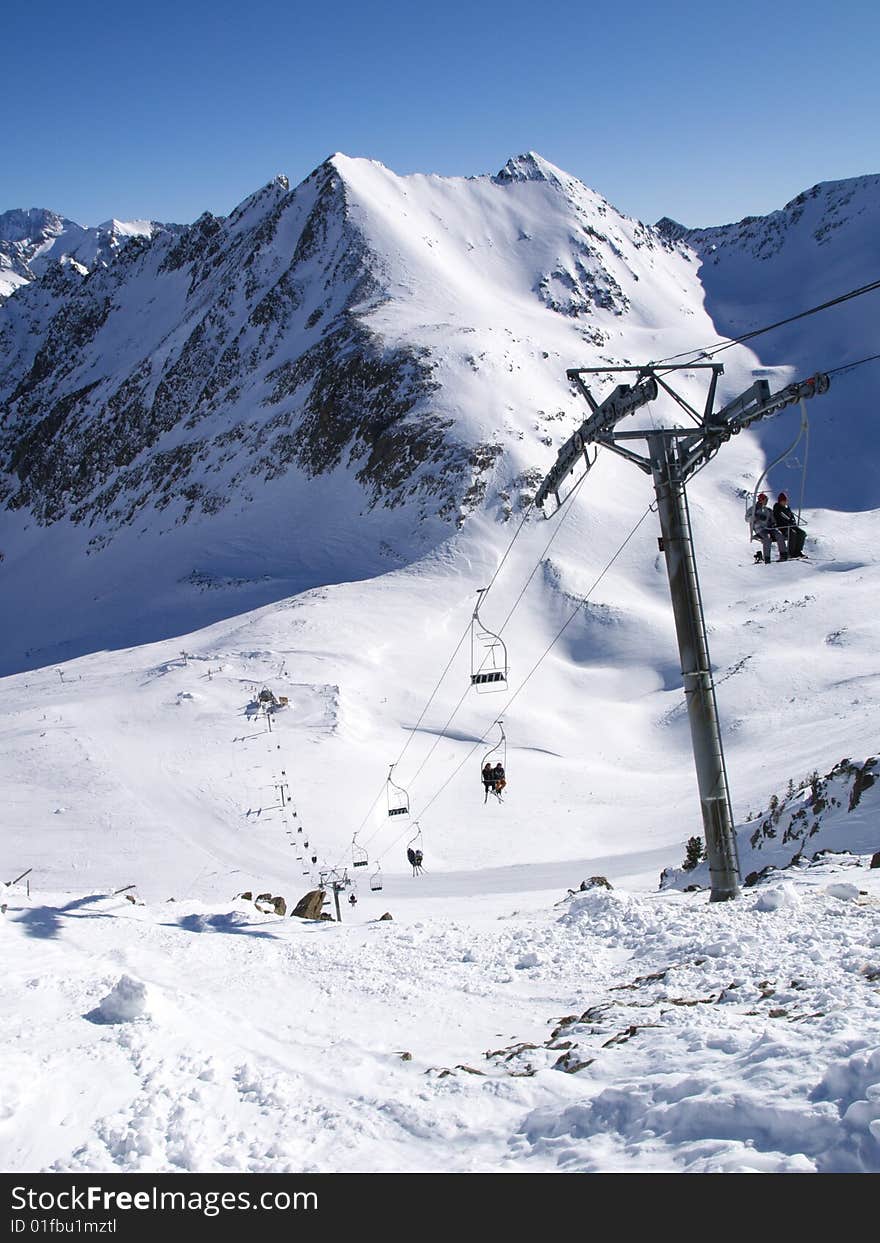 Ski lift with mountains and blue sky