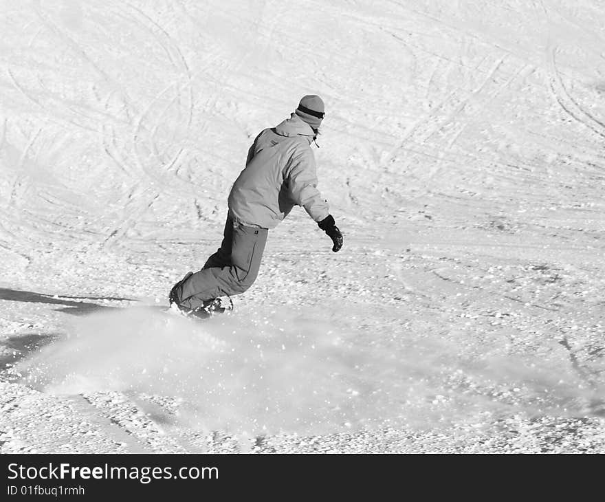 Snowboarder going down on the slope