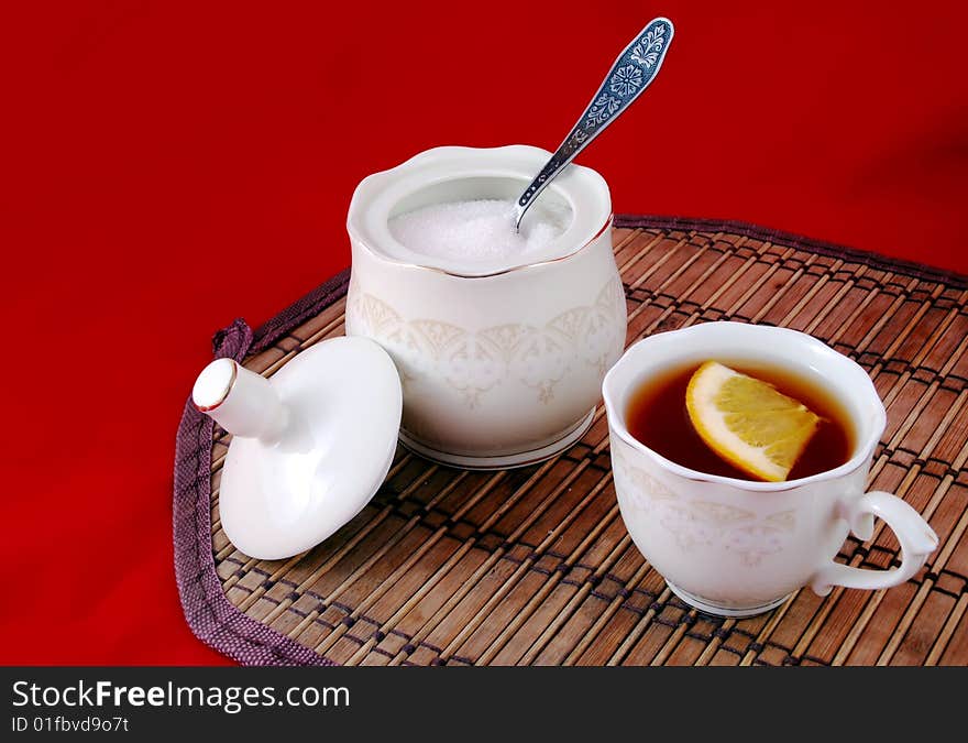 Beautiful still life cup of tea and lemon with sugar.