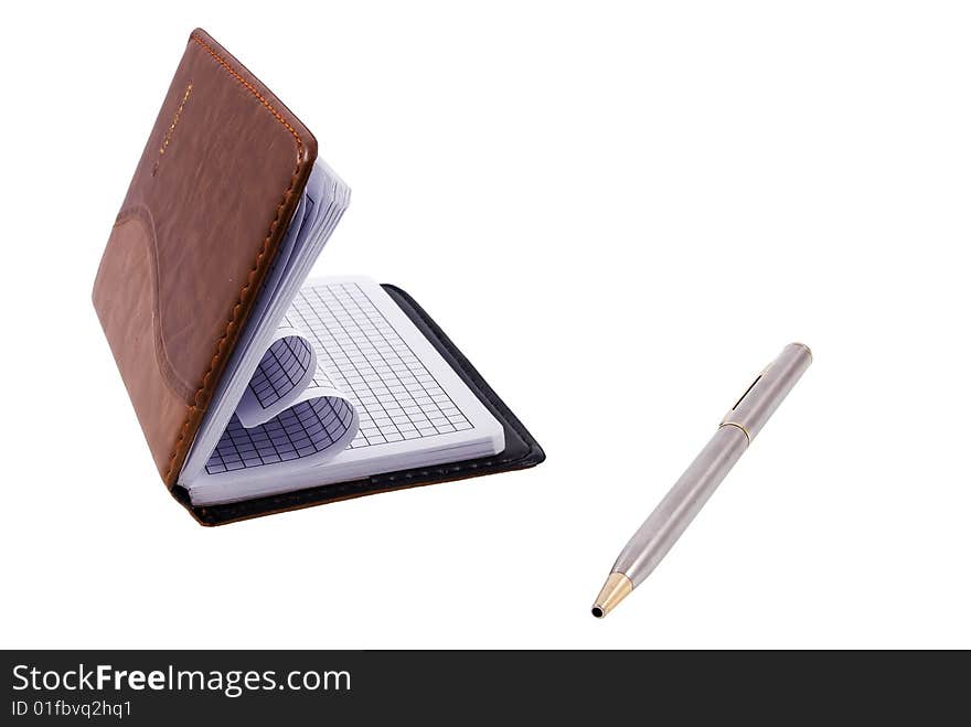 Notebook and a silver pen isolated on a white background