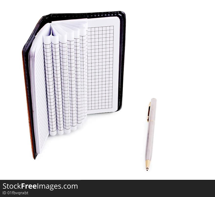 Notebook and a silver pen isolated on a white background