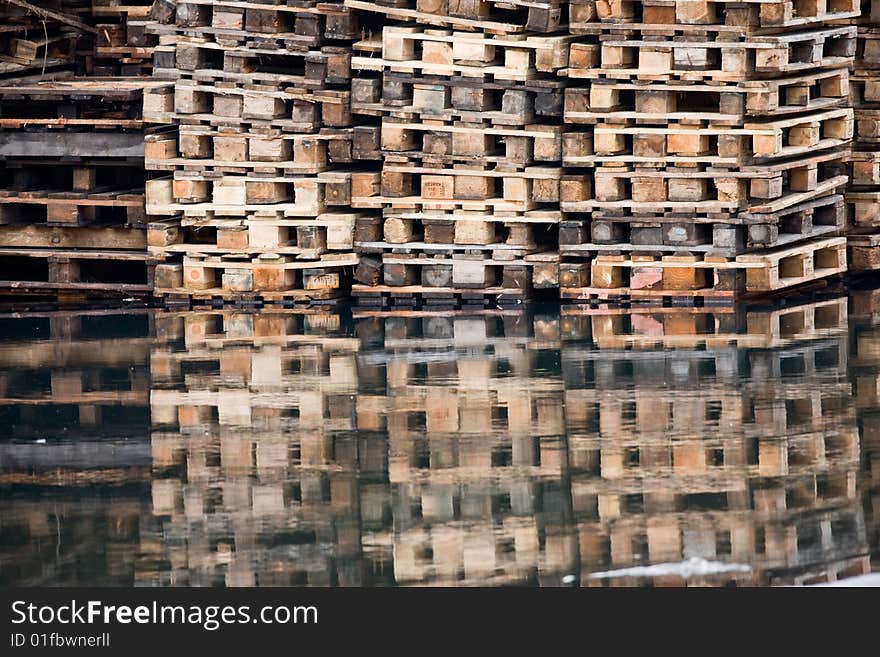 Stacks of wooden shipping pallets on water