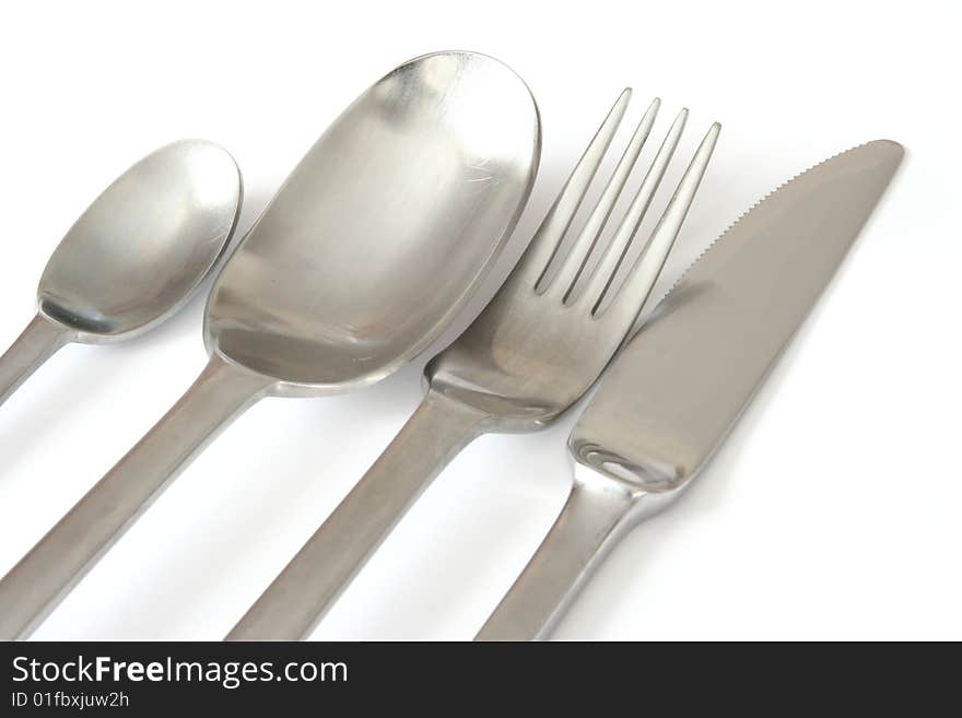 Spoons , knife and fork isolated over white , close-up. Spoons , knife and fork isolated over white , close-up