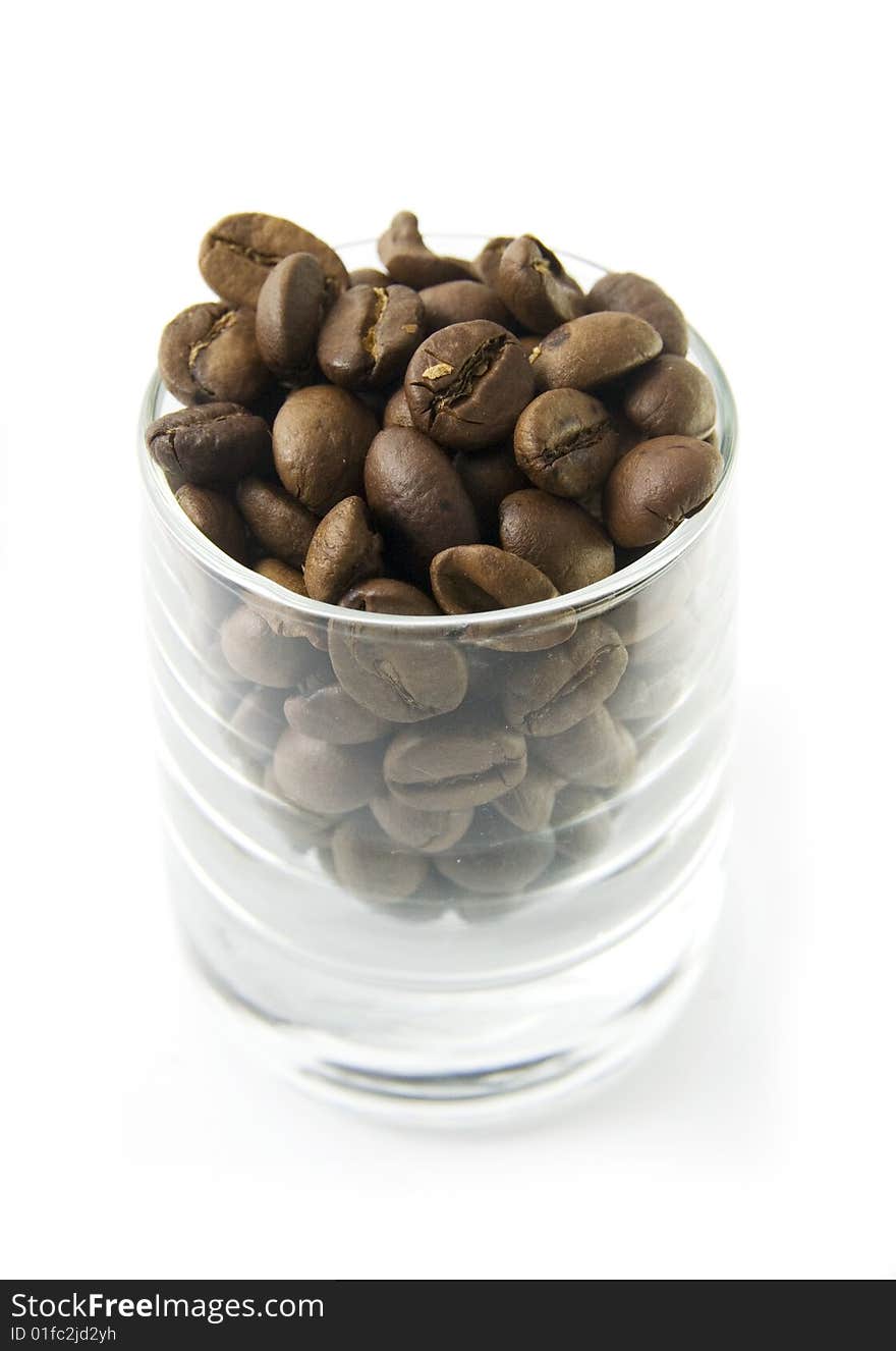 Coffe beans in glass on white background