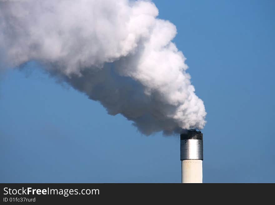 Chimney with smoke on with blue sky. Chimney with smoke on with blue sky