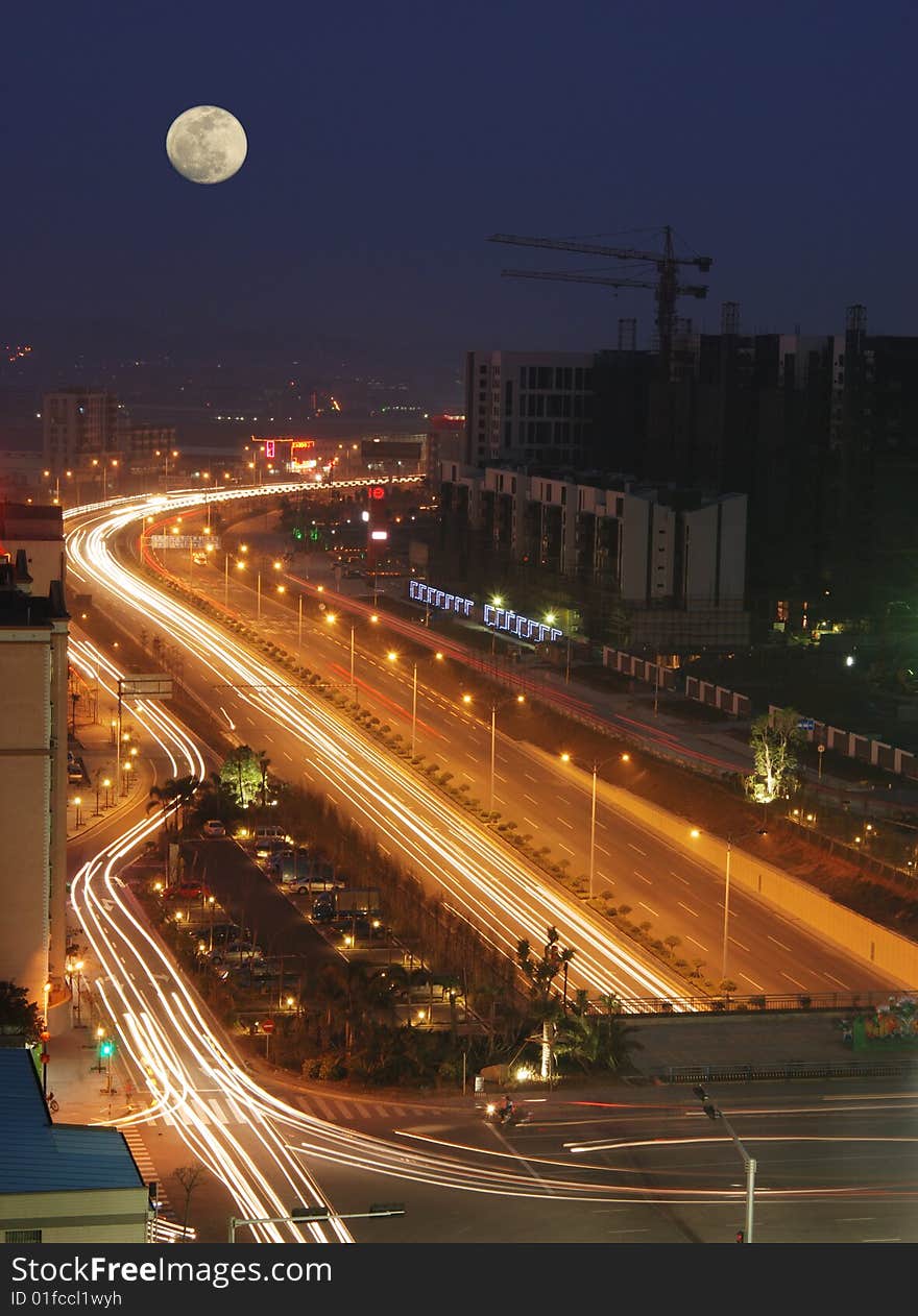 It is the night scene of Foshan city.under the moon,a road leading there from here. It is the night scene of Foshan city.under the moon,a road leading there from here.