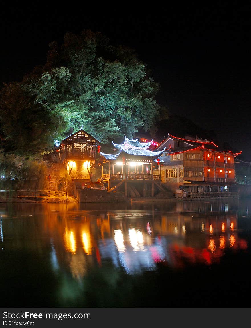 Is Chinese Hunan, Phoenix in evening here，there are three houses that the adornments wear neon light by the river. Is Chinese Hunan, Phoenix in evening here，there are three houses that the adornments wear neon light by the river.