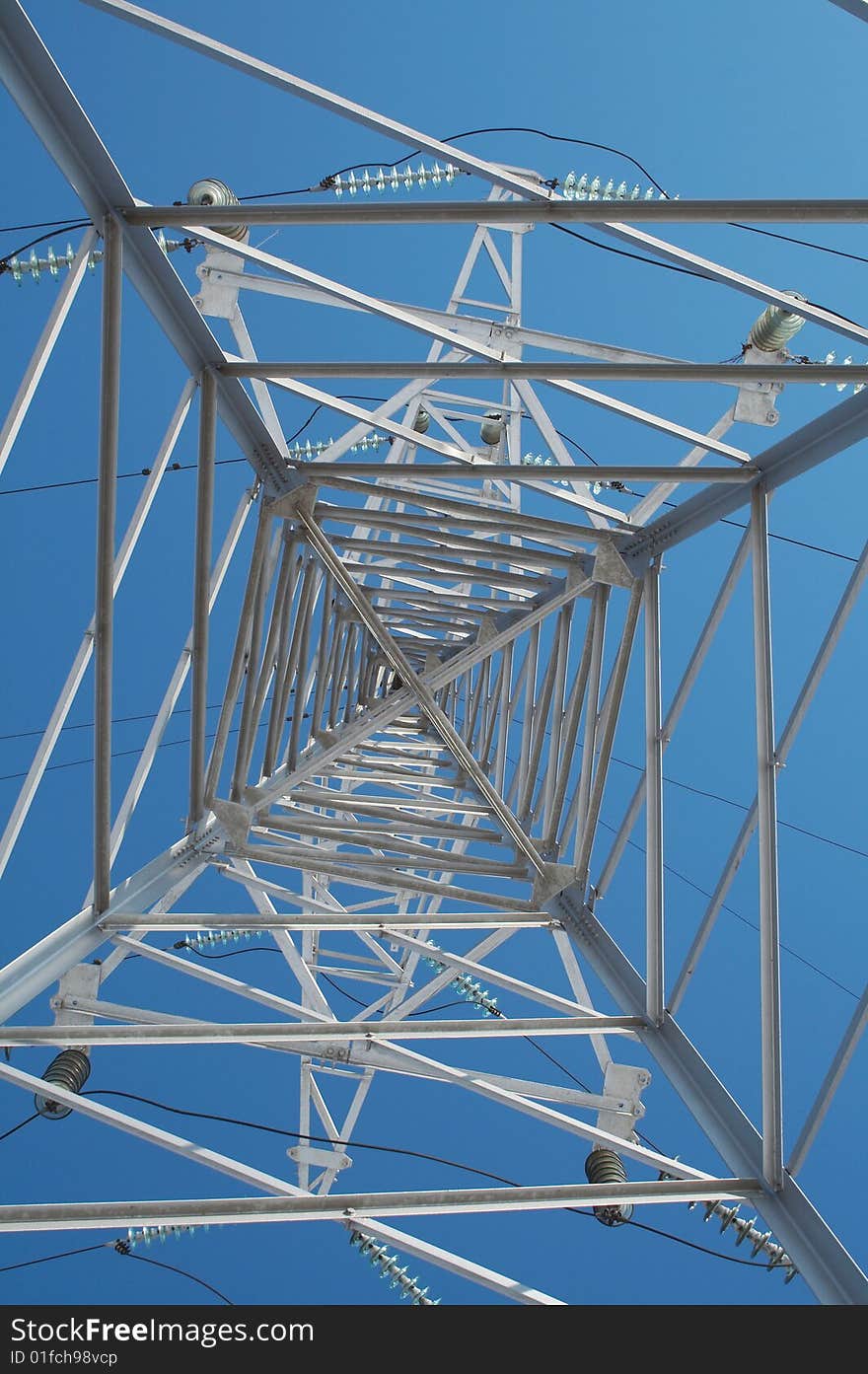 High-voltage prop against the background of blue sky. High-voltage prop against the background of blue sky.