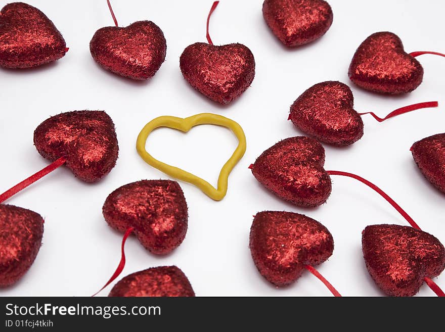 Red hearts reaching one yellow heart made from plasticine in the center. Red hearts reaching one yellow heart made from plasticine in the center