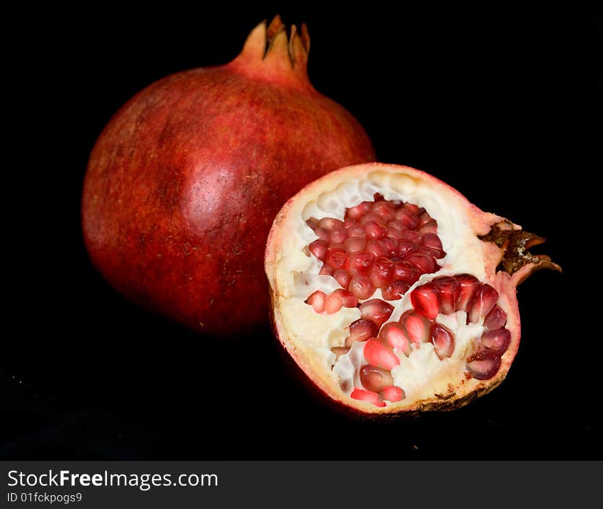 Pomegranate isolated on black background