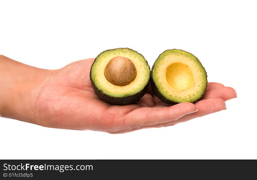 Halves of avocado on palm isolated on white background