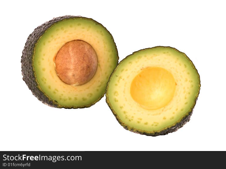 Sections of avokado looking like cross-section of Earth. Sections of avokado looking like cross-section of Earth