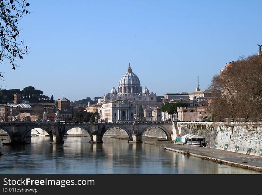 St. Peter's Basilica and Ponte Sant Angelo reflected in the Tiber river (Rome, Italy. St. Peter's Basilica and Ponte Sant Angelo reflected in the Tiber river (Rome, Italy